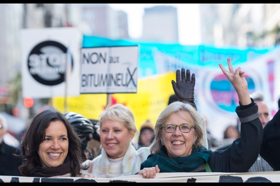 Green Party leader Elizabeth May, right, participates in a No to Energy East and Line 9B Pipelines demonstration in Montreal, Saturday, October 10, 2015.