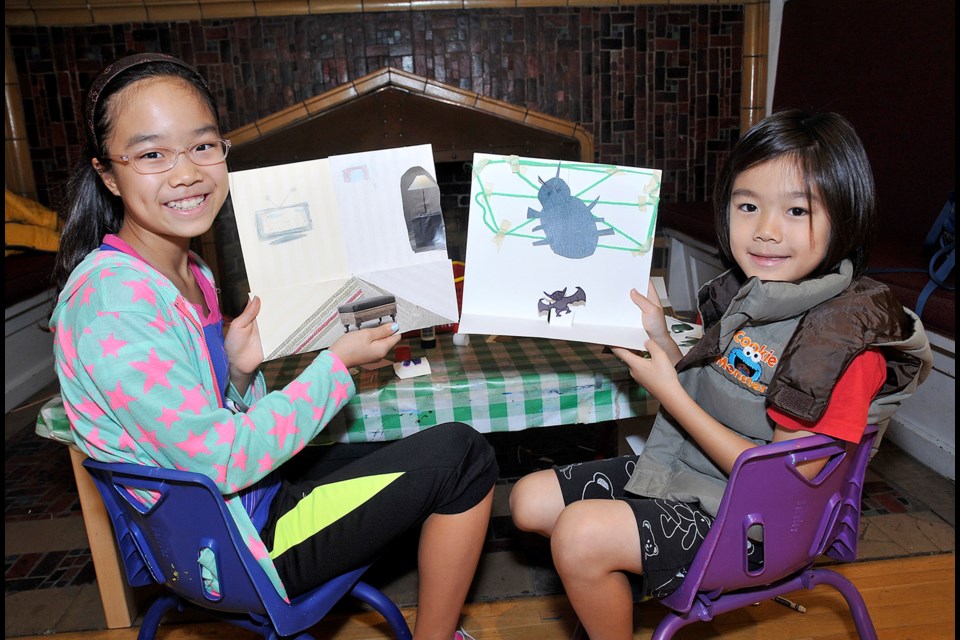 Alice (left),9, and Julian, 6.5, Kim show off their creation. at the In the BAG studio drop-in program on Oct. 11. The session’s theme was Drawing Spaces.