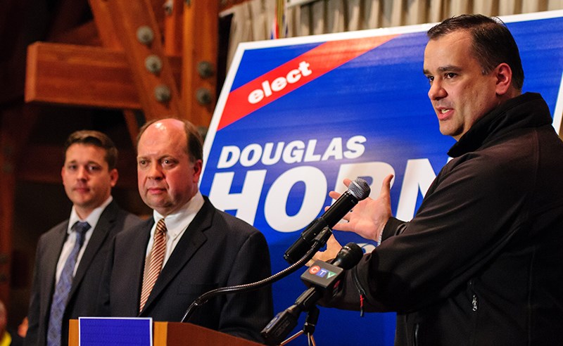 Former Tory MP and Industry Minister James Moore congratulates Conservative candidates Doug Horne (centre) and Tim Laidler for running for federal office.