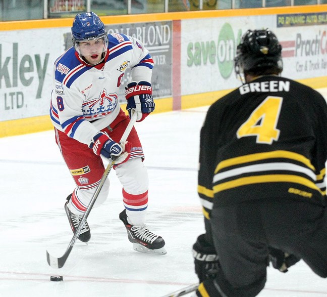 Jake LeBrun (white) looks for a way around defenceman Taylor Green (black) as the Prince George Spruce Kings took on the Coquitlam Express on Friday at the Coliseum, in the first game of a weekend doubleheader. Citizen Photo by James Doyle October 23, 2015