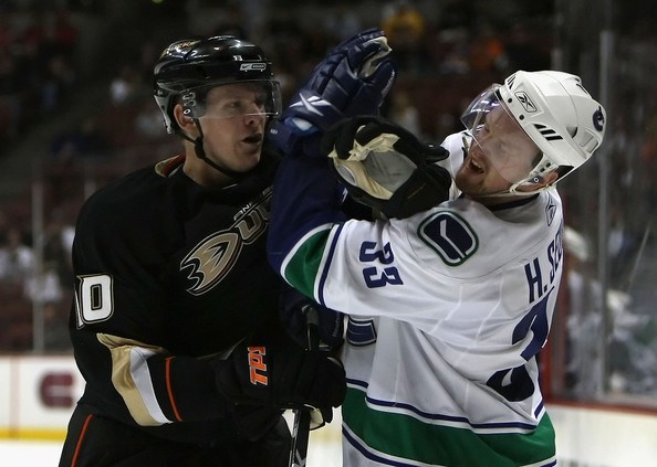 Corey Perry punches Henrik Sedin