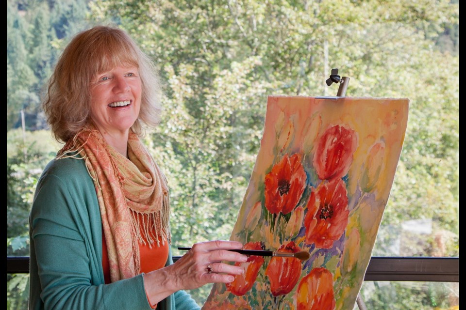 Artist Jennifer Lawson paints on her back porch surrounded by nature.