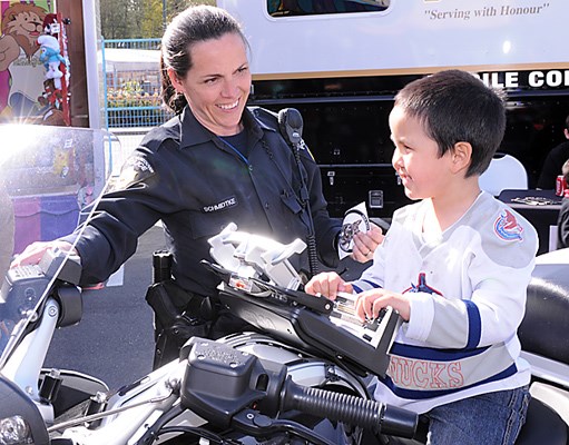 WV Police Cst. Lisa Schmidtke lets Preston Peters hop on a police motorcycle at the West Vancouver Police Family Carnival held at Park Royal south.Amusement rides and games along with West Vancouver Police displays were all part of the four day long event.