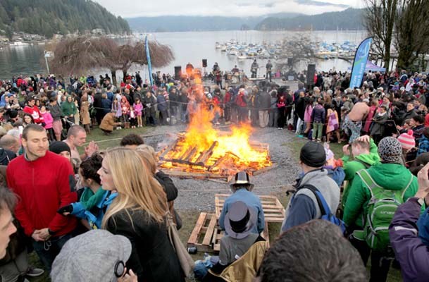 People gather around the bonfire to stay warm.