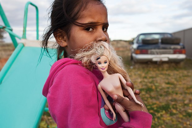 David Maurice Smith: "To put this image in context it is important to know that for a young Aboriginal girl in Australia the future looks very different to that of her non-Aboriginal counterparts. The socio-economic divide that exists is very confronting. The girl in this picture is someone I have spent time with and I have photographed her and her family over a period of several years however this is one of the first images I took of her. She was playing with her sisters in an abandoned lot near her guardian’s home on a day when her biological mother had come to visit them. It was a difficult situation as the kids really did not want any part of their mom. There is an intensity in her gaze that really grabs me ... and for me there is a large amount of symbolism found in her connection to the doll she is clutching, a symbol of unattainable standards."