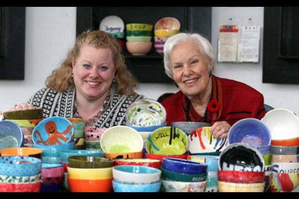 Alexa Lindroos and Helen Hughes with some of the more than 100 bowls up for grabs at the upcoming Souper Bowls of Hope fundraiser.