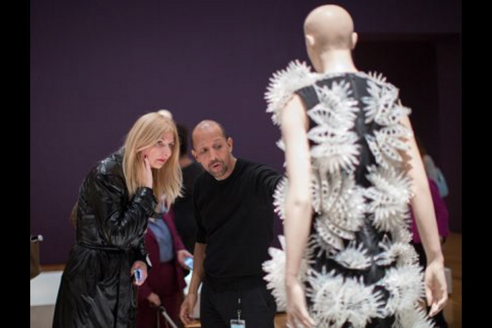 IVH Group CEO Bradly Dunn Klerks, right, talks to Tijana Lehtikoski about a piece from the Voltage collection by designer Iris van Herpen at Atlanta's High Museum.