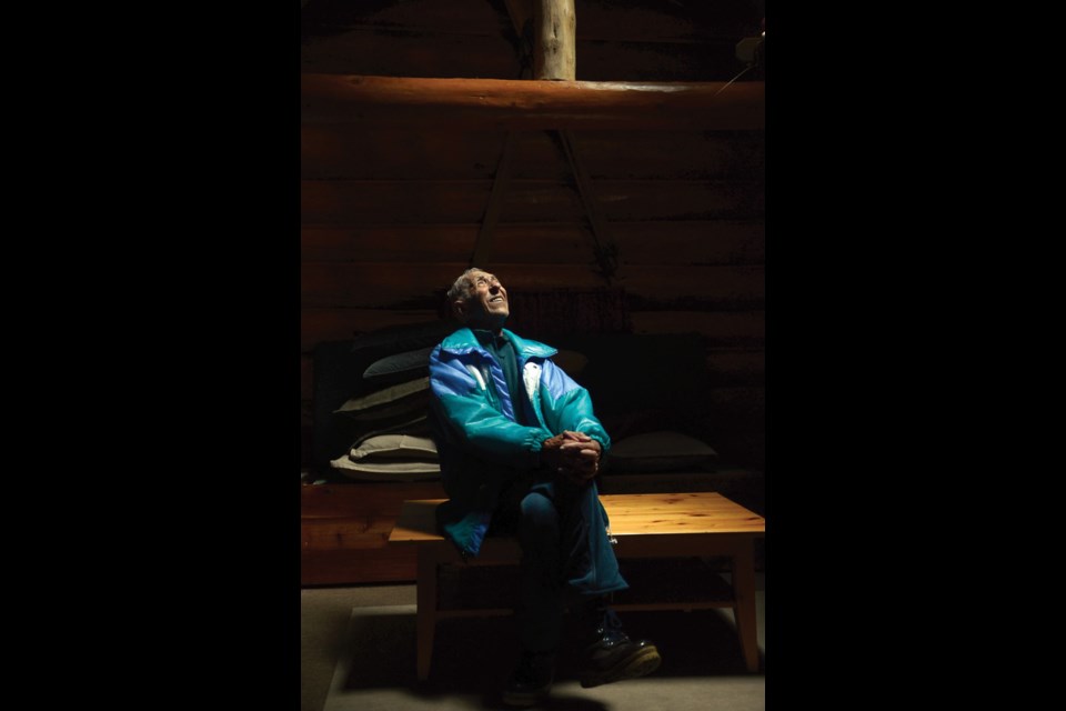 James Craig enjoys a quiet moment inside his cabin on West Vancouver's Hollyburn Ridge. The tiny log home, built in the 1930s, is one of about 100 left on the mountain.