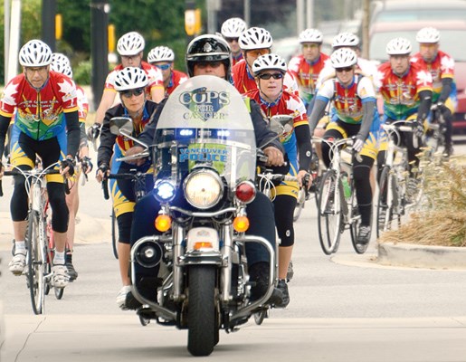 Riders arrive at North Vancouver's Civic Plaza with a friendly police escort.