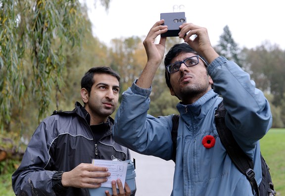 Sanmeet Chahal, right, and Jessy Uppal test the nitrate levels in the water of the Brunette River in lower Hume Park during Sunday’s creek clean-up event.
