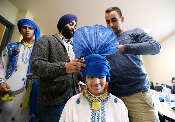 Gursaj Maan is assisted in putting on his turban prior to the Asian Arts Bhangra club's performance at Queensborough Community Centre on Sunday, Nov. 8.