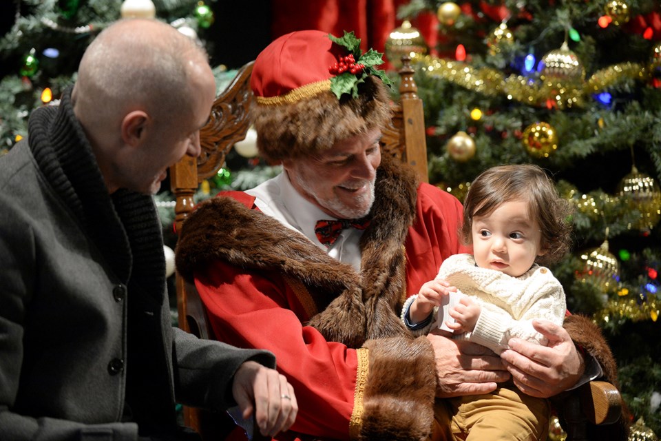 Mark Dawson and one-year-old Raphael visit with Father Christmas.