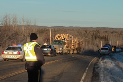 Cars were lined up at Mile 60 of the Alaska Highway after a head-on collision Tuesday morning. A police cruiser led a procession of about a dozen cars going towards Dawson Creek on the Alaska Highway near the scene of the accident. Cars were advised to turn away from the accident when safe to do so.