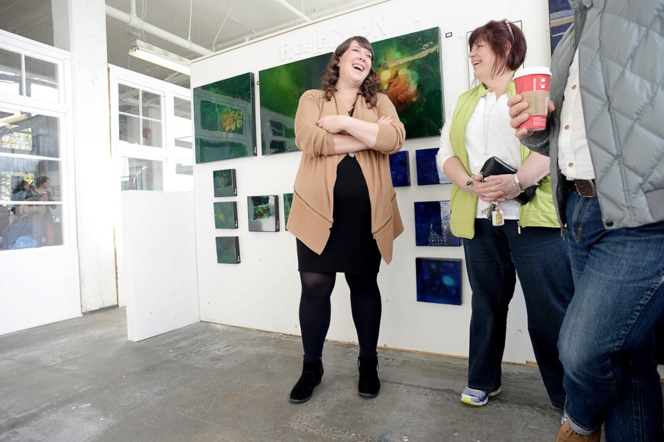 Artist Corinn Howes enjoys last year's winter art market at 100 Braid Street Studios. This year's market is set for Dec. 5.