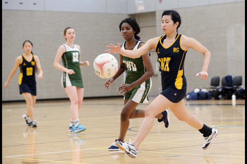 Moving down court, Team B.C.'s Sophia Chen stays a step ahead of her Alberta rival during the Western Canadian U-18 netball championships at the Fortius Centre in Burnaby.