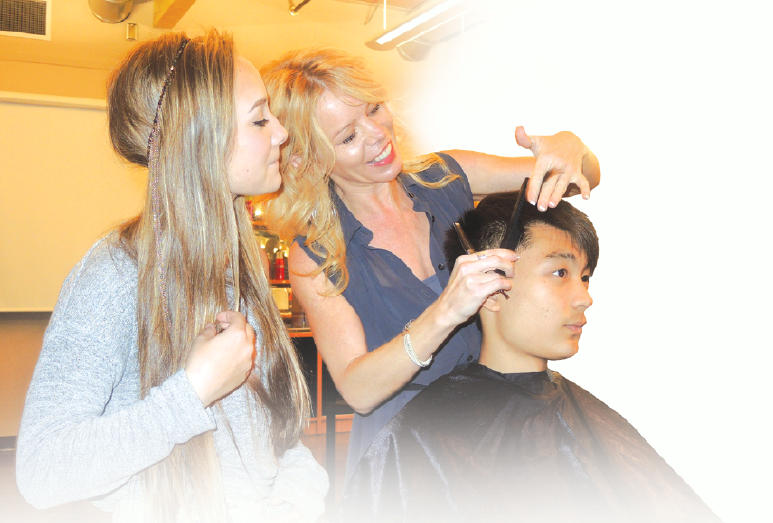Hugh Boyd secondary’s hair design instructor, Rhonda Stangeland, centre, guides hairstylist student Tara Balsdon, left, through a trim in the school’s salon. Photo by Alan Campbell/Richmond News. (November 2015)