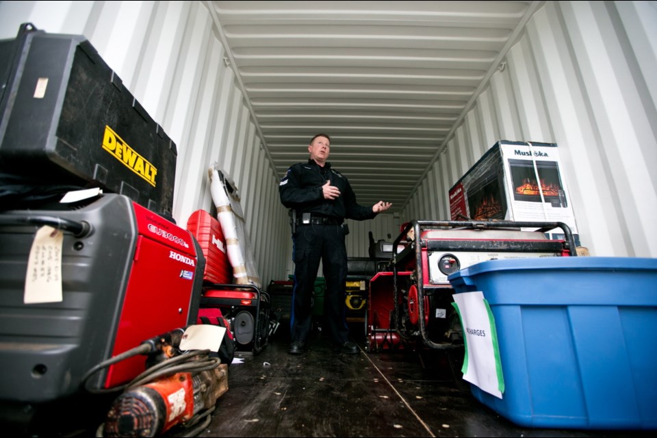 Saanich police Sgt. Steve Eassie surveys stolen goods that were seized from a home in Saanich. Police had to rent a large storage container for the overflow of assets that came from as far north as Parksville on the Island and as far east as Nelson on the mainland.