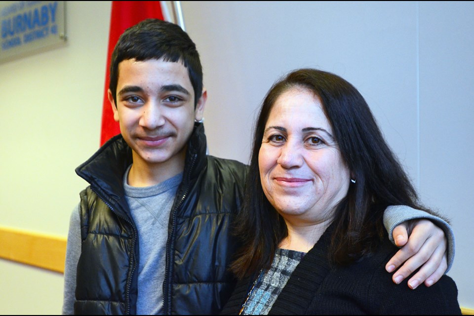 Saela Haj Mohamad, right, and her son Ojalan Shaikho, now a Grade 9 student at Burnaby South Secondary, came to Vancouver in April with three other family members after escaping civil war in Syria two years ago.
