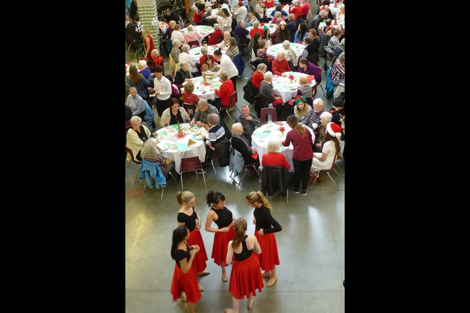 Heritage Woods secondary school's main concourse was turned into a festive holiday scene Friday as students feted local seniors with dainty treats and savories, music and dance. Some 200 people turned out for the 11th annual event that was organized by students working on an independent studies program.