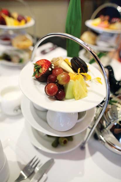 A three-tier serving dish displays the tea-infused sweets and savouries offered as part of the store's Taste of India Petite Afternoon Tea, on until Aug. 15.