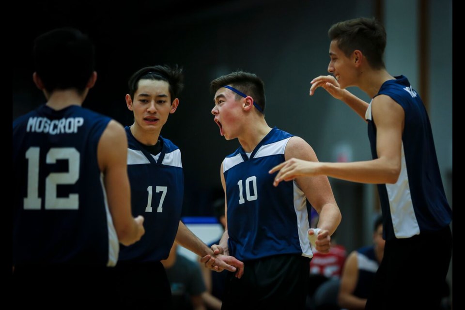 Moscrop's Jerry Yan (No. 12), Tatsuki Taylor, Justin Yee and Sandeep Moore celebrate a point during Saturday's B.C. boys AAA volleyball championship bronze medal match.