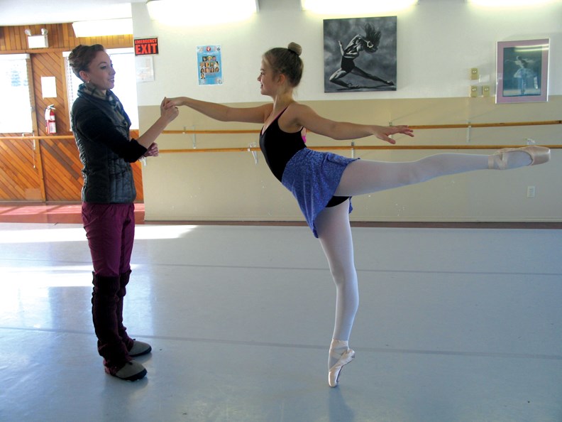 Erin McNeill, aka the Sugar Plum Fairy, coaches Jasmyn Evered in a graceful arabesque.
