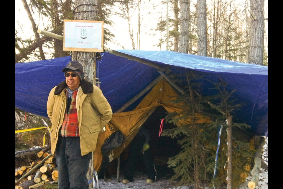Former Treaty 8 Tribal Chief Bud Napoleon stands at the old Rocky Mountain Fort site near the Moberly River, where Site C opponents have set up a protest camp.