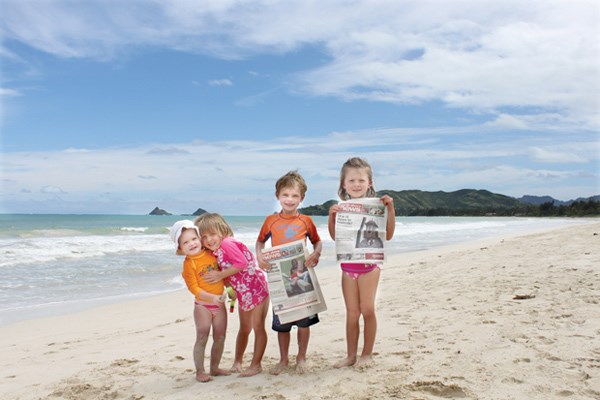 Kai and Mia Van and Ella and Sasha Thompson hang out on the beach in Kailua, Oahu.