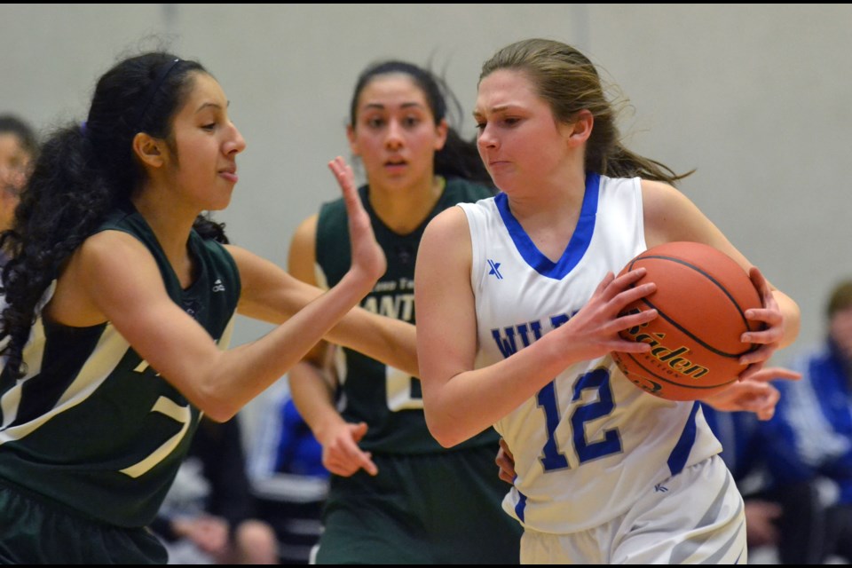 Abby Zawada fights her way towards the basket during McMath's quarter-final win over Tweedsmuir at the Tsumura Basketball Invitational at the Langley Events Centre
