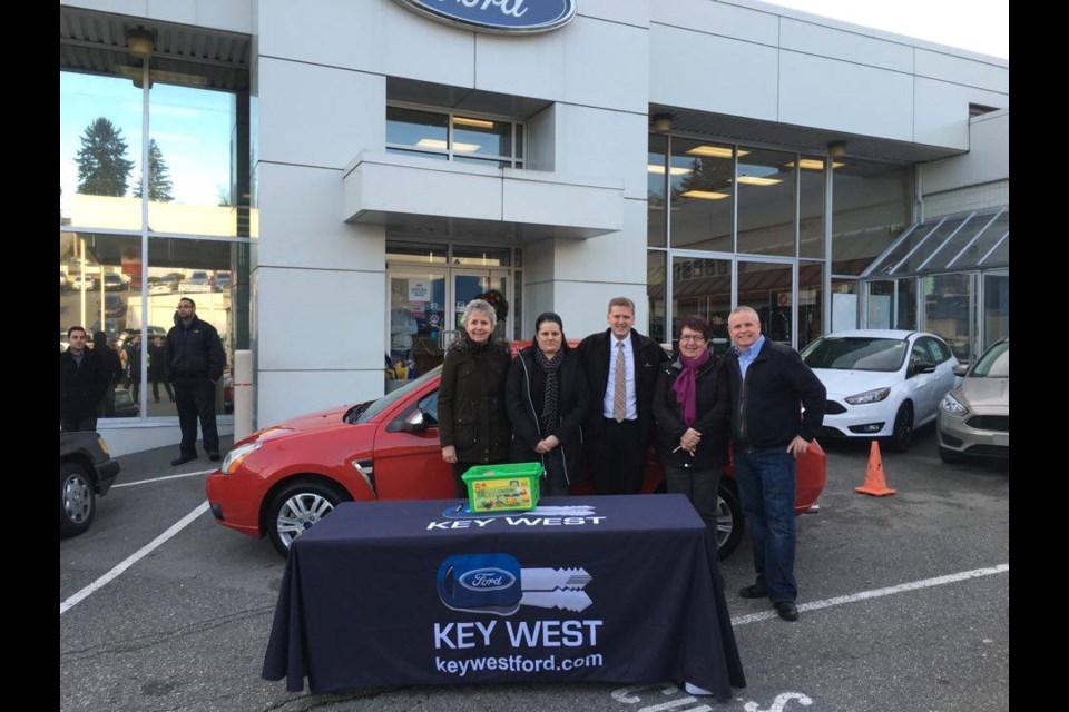 Fay Duxbury and Sandra Ostojic of Family Place, from left, joined Mayor Jonathan Cote, Family Place executive director Marjorie Staal and Key West Ford general manager Adam Isfeld at a draw for a 2008 Ford Focus SE. Key West Ford provided a car for the raffle, which raised funds for New Westminster Family Place.