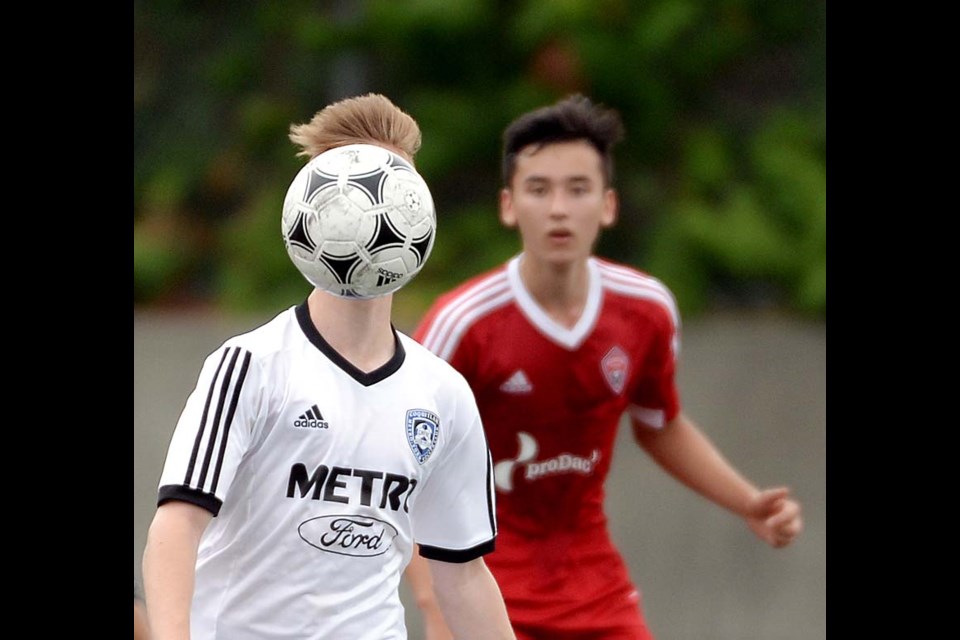 This Metro-Ford soccer player gets behind the ball during the High Performance boys u-15 final against Mountain United, one of many great sports photos snapped by the Burnaby NOW photographers in 2015. Photograph By Jennifer Gauthier - See more at: http://www.burnabynow.com/sports/a-wrap-on-2015-year-in-sports-1.2142231#sthash.icxPJjpN.dpuf