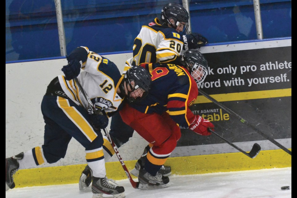 Richmond Midget A1 Blues Jovan Jankovic and James Houston battle along the boards during their team's 3-2 win over Alaska at the 35th annual RIBMHT.