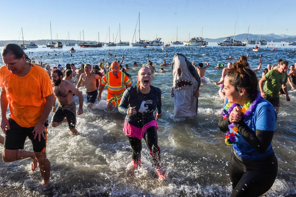 At least three thousand people braved the frigid waters of English Bay, January 1st, 2016, for the Vancouver Polar Bear Swim Club’s 96th annual dip. Photograph by: Rebecca Blissett