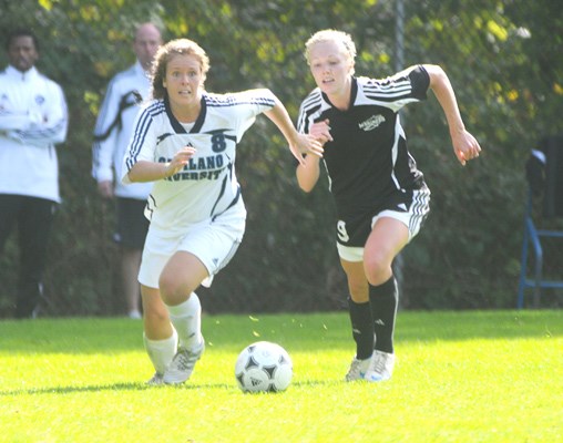 Kristine Hiduk for Capilano races her Mariners opponent to the ball.
