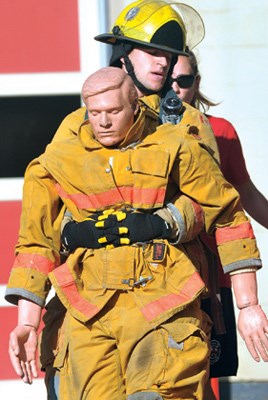 Sean Bosa works hard as he drags a dummy during a "skills and abilities" testing session at the District of North Vancouver Fire Training facility.