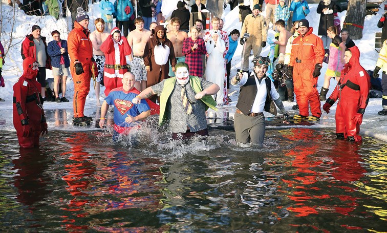 Although not required, many of the 53 or so participants wore costumes when they braved the -15 Celsius temperatures to jump into the water at the 15th Annual Polar Bear Dip at Ness Lake Bible Camp on Friday. All money raised went to camp sponsorship fund which allows children to attend camp who otherwise would be unable to afford it. Citizen Photo by James Doyle January 1, 2015