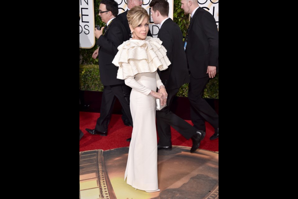 Jane Fonda wore Yves Saint Laurent Couture that had stiff sequined ruffles up top, flowing over the shoulders of the long-sleeve gown at the 73rd annual Golden Globe Awards.