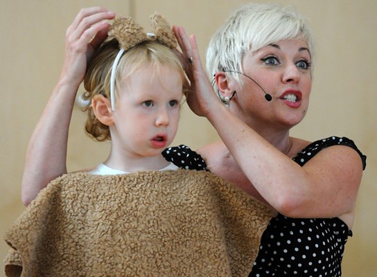 3-year-old Liam Bulger gets dressed up as a bear for a song performance by Angela Kelman. Families were invited to Lynn Valley Main Library for the summer reading celebration.