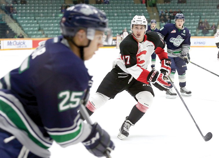 Prince George Cougars Luke Harrison skates in hard on the forecheck as he eyes up Seattle Thunderbirds Ethan Bear on Tuesday at CN Centre. The Thunderbirds were in town to take on the Cougars in the first game of a midweek doubleheader. Citizen Photo by James Doyle January 12, 2016