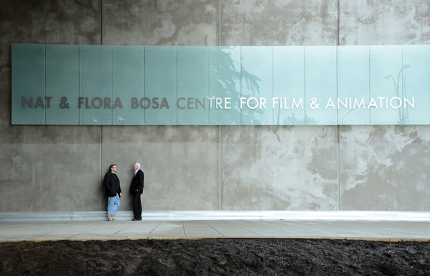 Bill Thumm, centre director, (left), and Peter Leitch, chairman of the Motion Picture Production Industry Association of B.C., chat beneath the sign at the entrance to the Nat & Flora Bosa Centre for Film & Animation at Capilano University.