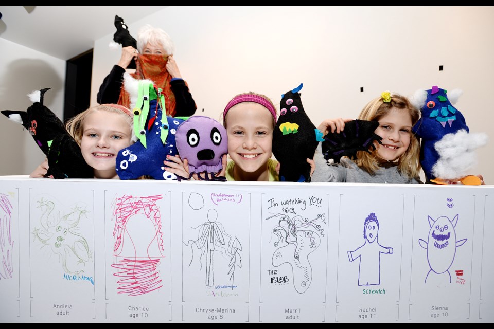 Nothing scary here: Patricia, at rear, and Sienna, Charlee and Andie, from left, are joined by some “scaries” they created for the Making Scaries exhibit at the secret Gallery at Anvil Centre. Local kids and seniors worked together on the project aimed at talking about the meaing of “scary.”