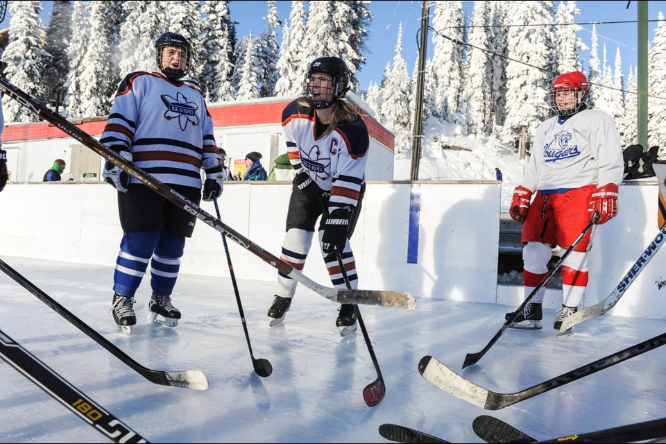 Ice-O-Topes captain Shannon Saunders lead the team with a pre-game cheer Friday at Apex Mountain Resort’s outdoor hockey rink during the Apex Shoot-Out tournament. The Topes dropped a 7-2 game to the Warriors, another women’s recreational hockey team from Vancouver. The Warriors also beat the Topes 7-3 in Sunday’s final. Photograph by: Rebecca Blissett