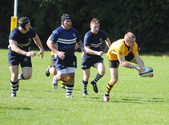 Three Burnaby players in pursuit of a Capilano player.