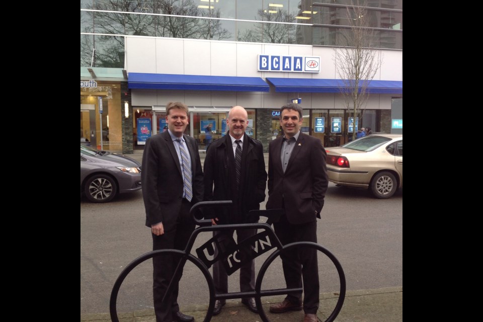 The Uptown BIA funded 18 new racks through a levy collected from area businesses. From left, Mayor Jonathan Cote, Wayne Beattie of Westminster Centre and Coun. Patrick Johnstone recently checked out the new bike racks.