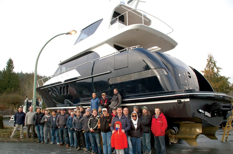 Coastal Craft crew with the 65-foot luxury yacht they just finished creating for a customer in the U.S. The vessel is wheelchair accessible.