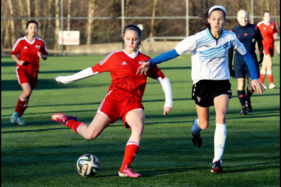 Burnaby Metro's Sophie Lesjak, in red, winds up to send the ball toward the net during last week's game against North Shore in Metro Select under-18 girls league play.