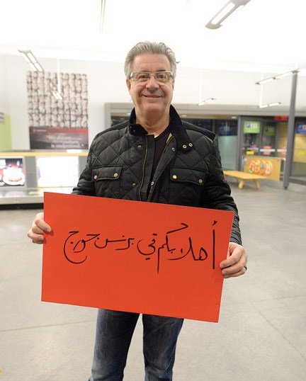 Mayor Lyn Hall holds up a sign that says 'welcome to Prince George' in Arabic. Citizen photo by Brent Braaten Jan 8 2016