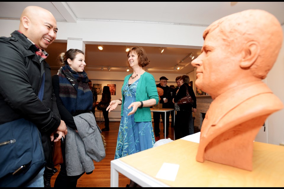 Artist Louise Solecki Weir with her piece Stephen Harper (Or In Considerations of the Controversial History of Political Statuary) (terracotta) at the opening reception for Moved by Portraits.