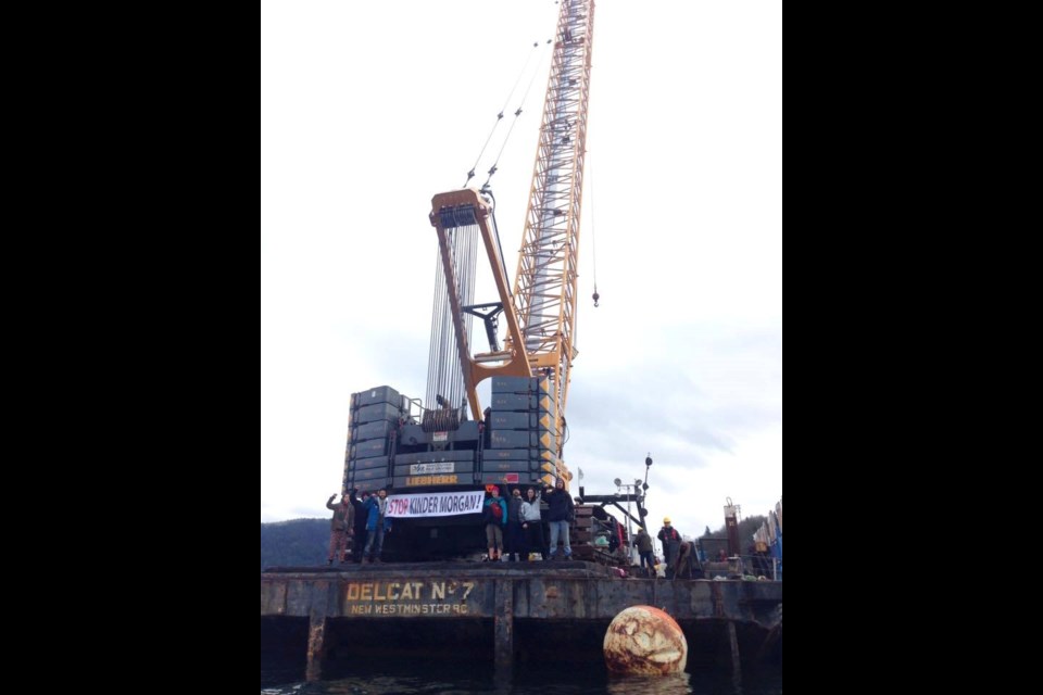 This activist-submitted photo shows seven people on Kinder Morgan's drilling barge Monday morning with an anti-Kinder Morgan banner. The Burnaby RCMP arrested seven people Monday for boarding the barge, which the company is using to conduct underwater drilling for soil samples.