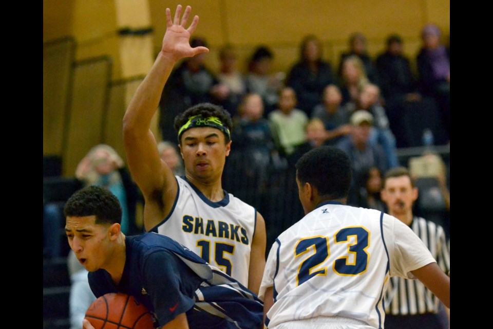 Nigel Boyd and Ahmed Mohamud smother a Byrne Creek opponent during Saturday's championship game at the Bob Carkner Memorial Classic. Boyd scored 42 points as the host Sharks rallied to win the tournament for the first time in three years.